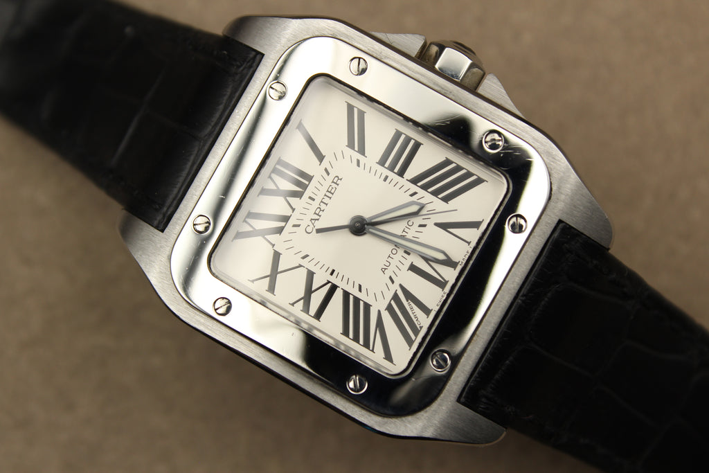 Montre Cartier Santos 100 pour homme en acier, vendue par prestigeandtime.com, présentée en occasion authentique en excellent état avec full set, modèle emblématique idéal pour collection ou investissement horloger.