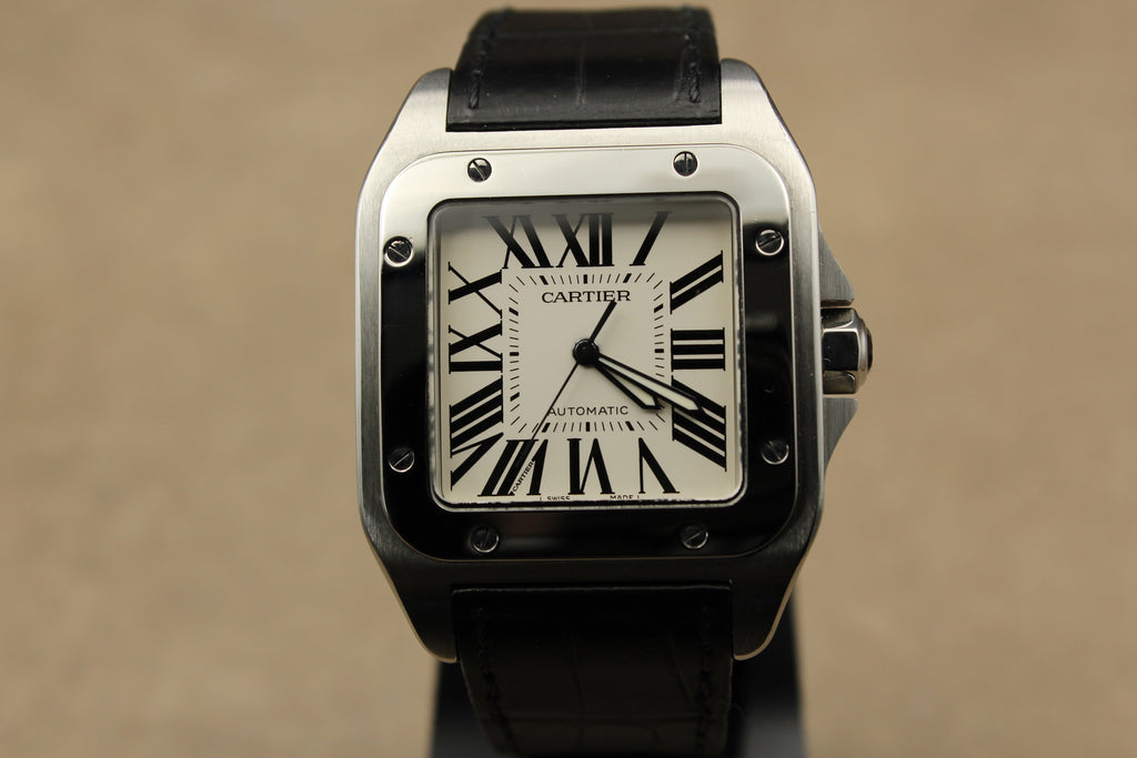 Montre Cartier Santos 100 pour homme en acier, vendue par prestigeandtime.com, présentée en occasion authentique en excellent état avec full set, modèle emblématique idéal pour collection ou investissement horloger.