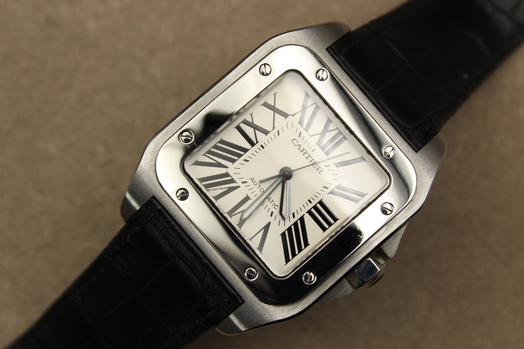 Montre Cartier Santos 100 pour homme en acier, vendue par prestigeandtime.com, présentée en occasion authentique en excellent état avec full set, modèle emblématique idéal pour collection ou investissement horloger.