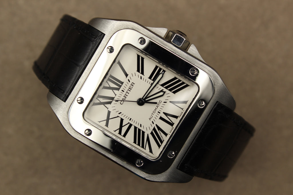 Montre Cartier Santos 100 pour homme en acier, vendue par prestigeandtime.com, présentée en occasion authentique en excellent état avec full set, modèle emblématique idéal pour collection ou investissement horloger.