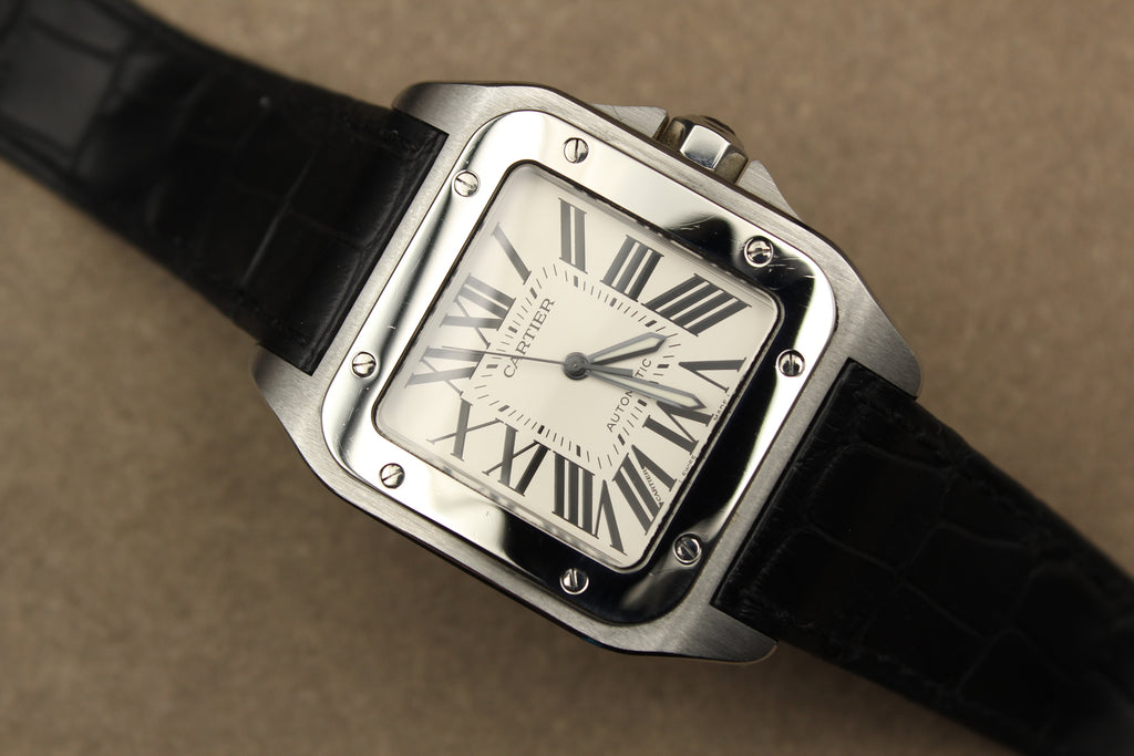 Montre Cartier Santos 100 pour homme en acier, vendue par prestigeandtime.com, présentée en occasion authentique en excellent état avec full set, modèle emblématique idéal pour collection ou investissement horloger.
