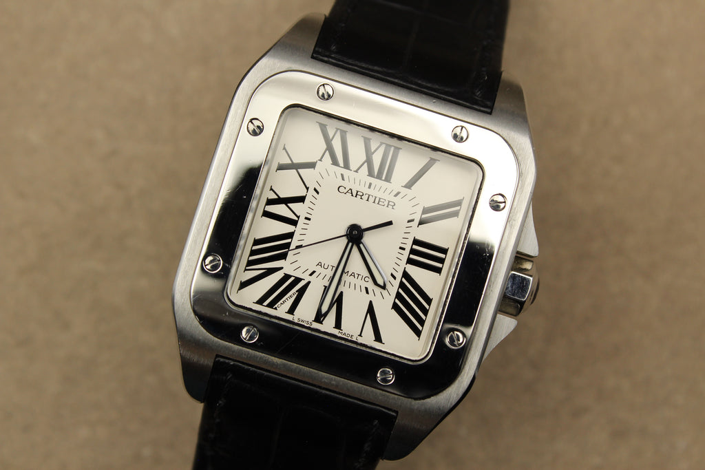 Montre Cartier Santos 100 pour homme en acier, vendue par prestigeandtime.com, présentée en occasion authentique en excellent état avec full set, modèle emblématique idéal pour collection ou investissement horloger.