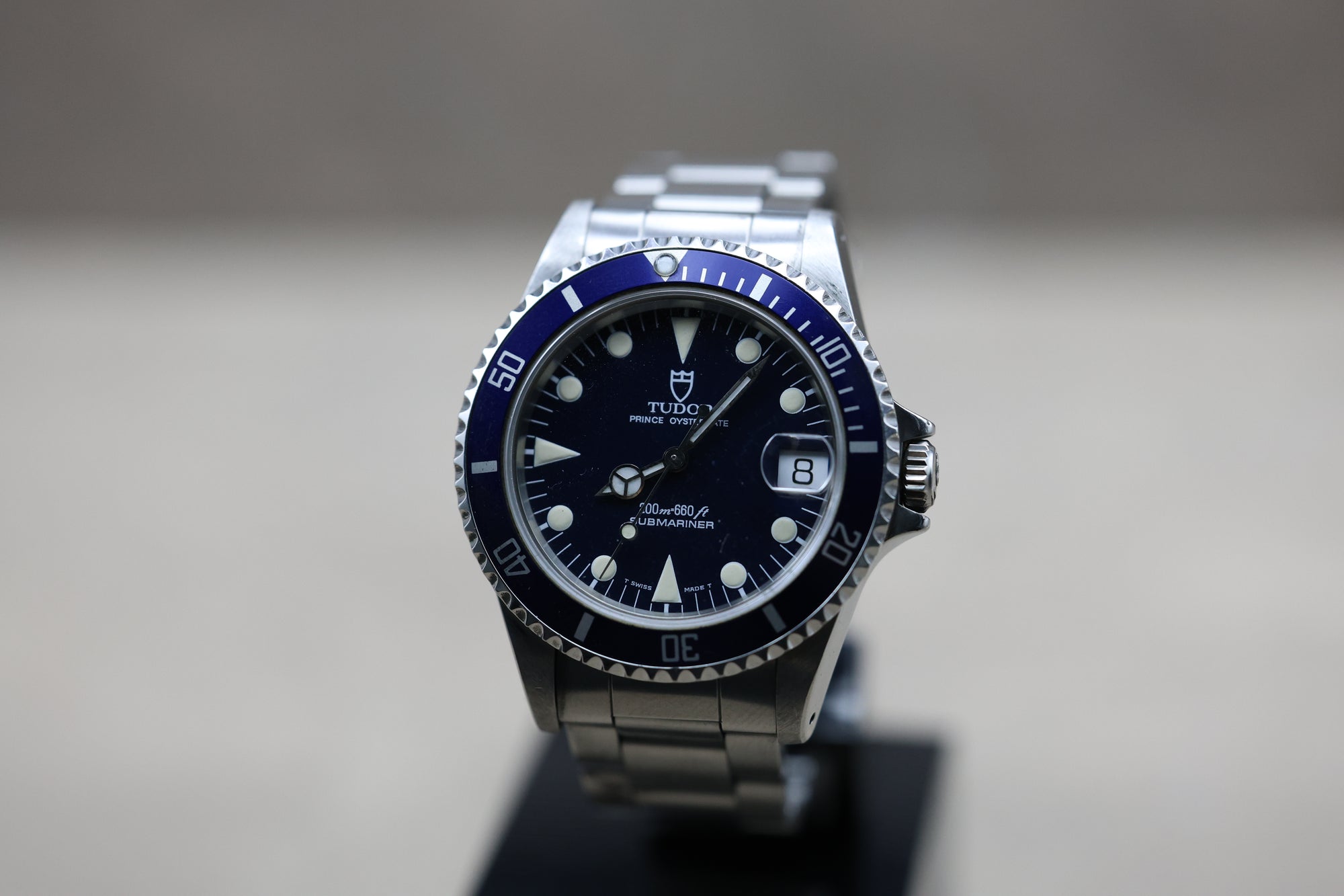 Vue macro cadran tritium Rolex Submariner collector avec couronne Rolex et fond de boîte gravé
